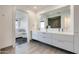 Bathroom featuring a large mirror and a double vanity, a glass shower and bedroom in the background at 4422 N 75Th St # 3012, Scottsdale, AZ 85251