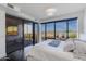 Bedroom with sliding glass doors to a deck with city views and a blue throw on the white bed at 4422 N 75Th St # 3012, Scottsdale, AZ 85251