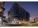 Modern multi-story condo building with glass balconies and contemporary architectural design at dusk at 4422 N 75Th St # 3012, Scottsdale, AZ 85251