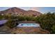 Aerial view showcasing the house and pool with mountain backdrop at 4450 N 54Th St, Phoenix, AZ 85018