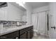 Bathroom featuring a double sink vanity with granite countertop and tiled shower at 5267 E Diatomite Dr, San Tan Valley, AZ 85143