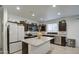 Bright kitchen with stainless appliances, dark wood cabinetry, and granite countertops open to the dining area at 5267 E Diatomite Dr, San Tan Valley, AZ 85143