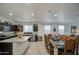 Bright kitchen with stainless appliances, dark wood cabinetry, and granite countertops open to the dining area at 5267 E Diatomite Dr, San Tan Valley, AZ 85143