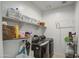 Functional laundry room featuring modern appliances, ample shelving for storage, and efficient layout for household tasks at 5267 E Diatomite Dr, San Tan Valley, AZ 85143