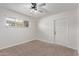 Well-lit bedroom featuring neutral wall paint and carpeted floors at 530 N Miller St, Mesa, AZ 85203