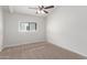 Bright bedroom with neutral carpeting and ceiling fan at 530 N Miller St, Mesa, AZ 85203