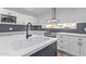 Modern kitchen with white cabinets, quartz countertops and black faucet at 530 N Miller St, Mesa, AZ 85203