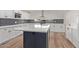 Modern kitchen with white shaker cabinets, quartz countertops and island at 530 N Miller St, Mesa, AZ 85203