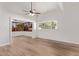 Bright living room with hardwood floors, ceiling fan and large windows at 530 N Miller St, Mesa, AZ 85203