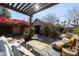 Charming backyard patio with a pergola, stylish seating, and beautiful landscaping at 537 W Encanto Blvd, Phoenix, AZ 85003