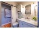 Elegant bathroom featuring a marble vanity, sliding barn door, and modern fixtures at 537 W Encanto Blvd, Phoenix, AZ 85003