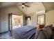 Bedroom with ceiling fan, mini-split AC, TV, and door leading to outdoor patio at 537 W Encanto Blvd, Phoenix, AZ 85003