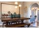 Elegant dining room featuring a rustic wooden table with decorative vases and lighting at 537 W Encanto Blvd, Phoenix, AZ 85003