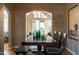 Dining room with dark wood table and chairs, leading to a bright living space at 537 W Encanto Blvd, Phoenix, AZ 85003