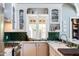 Charming kitchen with white cabinets, green backsplash, farmhouse sink, and window with decorative lattice at 537 W Encanto Blvd, Phoenix, AZ 85003