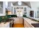 Bright kitchen boasts white cabinetry, green backsplash, stainless steel appliances, and vaulted ceiling at 537 W Encanto Blvd, Phoenix, AZ 85003