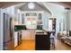 Charming kitchen with white cabinetry, green tiled backsplash, and stainless steel appliances at 537 W Encanto Blvd, Phoenix, AZ 85003