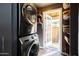 Modern laundry room with stacked washer and dryer and access to private outdoor patio at 537 W Encanto Blvd, Phoenix, AZ 85003