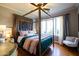 Stylish main bedroom with a four-poster bed and natural light at 537 W Encanto Blvd, Phoenix, AZ 85003