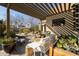 Relaxing outdoor patio area with a pergola, cozy seating, and lush greenery at 537 W Encanto Blvd, Phoenix, AZ 85003