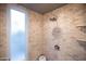 Modern shower with sleek fixtures, beige tile surround, and natural light from the frosted window at 537 W Encanto Blvd, Phoenix, AZ 85003