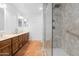 Main bathroom features double sink vanity and walk-in shower with glass enclosure at 5421 W Brown St, Glendale, AZ 85302