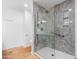 Modern bathroom with a walk-in shower featuring gray marble-look tile and grab bars for accessibility at 5421 W Brown St, Glendale, AZ 85302