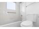 Bathroom featuring a shower and bath combination with white tiled walls and floors at 5421 W Brown St, Glendale, AZ 85302