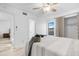 A bright bedroom featuring wood-look floors, ceiling fan, and decor with a stylish gray comforter set at 5421 W Brown St, Glendale, AZ 85302