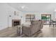 Bright living room features a fireplace, ceiling fan, and wood-look flooring at 5421 W Brown St, Glendale, AZ 85302