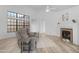 Bright living room features a fireplace, ceiling fan, and wood-look flooring at 5421 W Brown St, Glendale, AZ 85302