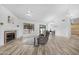 Bright living room features a fireplace, ceiling fan, and wood-look flooring at 5421 W Brown St, Glendale, AZ 85302