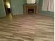 Living room featuring a fireplace and wood-look tile floors at 5421 W Brown St, Glendale, AZ 85302