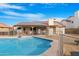 Backyard pool with safety fence and covered patio with a tile roof at 5421 W Brown St, Glendale, AZ 85302