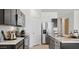 Modern kitchen with dark cabinetry, stainless steel appliances, and marble countertops at 5469 E Rock Bush Ln, San Tan Valley, AZ 85140