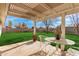 The back patio has a metal table and chairs overlooking the spacious backyard at 5603 W Bluefield Ave, Glendale, AZ 85308