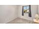 Cozy bedroom featuring neutral carpet, ample natural light, and a view of the outdoors at 5603 W Bluefield Ave, Glendale, AZ 85308