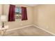 Bedroom showcasing a window with view, neutral carpet, and soft, natural lighting at 5603 W Bluefield Ave, Glendale, AZ 85308