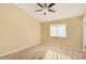 Bright bedroom featuring wood-look tile flooring, a ceiling fan, and ample natural light at 5603 W Bluefield Ave, Glendale, AZ 85308