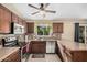 Stylish kitchen showcasing stainless steel appliances, tile backsplash, and hanging indoor plants at 5603 W Bluefield Ave, Glendale, AZ 85308