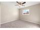 Bright bedroom with neutral walls, ceiling fan, and carpeted floors at 6201 W Maryland Ave, Glendale, AZ 85301