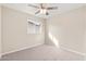 Simple bedroom with neutral walls, ceiling fan, and carpeted floors at 6201 W Maryland Ave, Glendale, AZ 85301