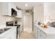 Modern kitchen with white shaker cabinets and a breakfast bar at 6201 W Maryland Ave, Glendale, AZ 85301