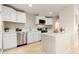 Modern kitchen with white cabinets, quartz countertops, and stainless steel appliances at 6201 W Maryland Ave, Glendale, AZ 85301