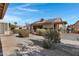 Home's backyard with covered patio and desert landscaping at 6871 S Coral Gable Dr, Chandler, AZ 85249