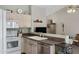 Kitchen with stainless steel dishwasher and a view into the living room at 6871 S Coral Gable Dr, Chandler, AZ 85249