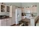 White kitchen features ample cabinetry and a view into the adjacent dining area at 6871 S Coral Gable Dr, Chandler, AZ 85249