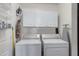 Laundry room with washer, dryer, and overhead cabinets at 6871 S Coral Gable Dr, Chandler, AZ 85249