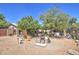 Spacious backyard with gravel ground, trees, and storage at 7201 W Alvarado Rd, Phoenix, AZ 85035