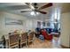 Dining room with table and four chairs, adjacent to living room at 7201 W Alvarado Rd, Phoenix, AZ 85035